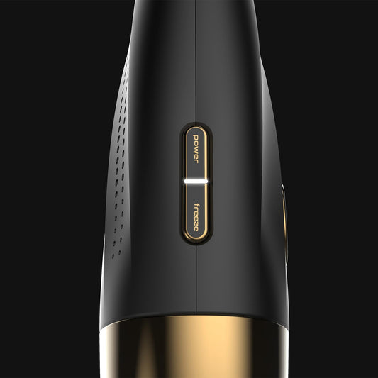 Black and gold electronic device with power button on a black background